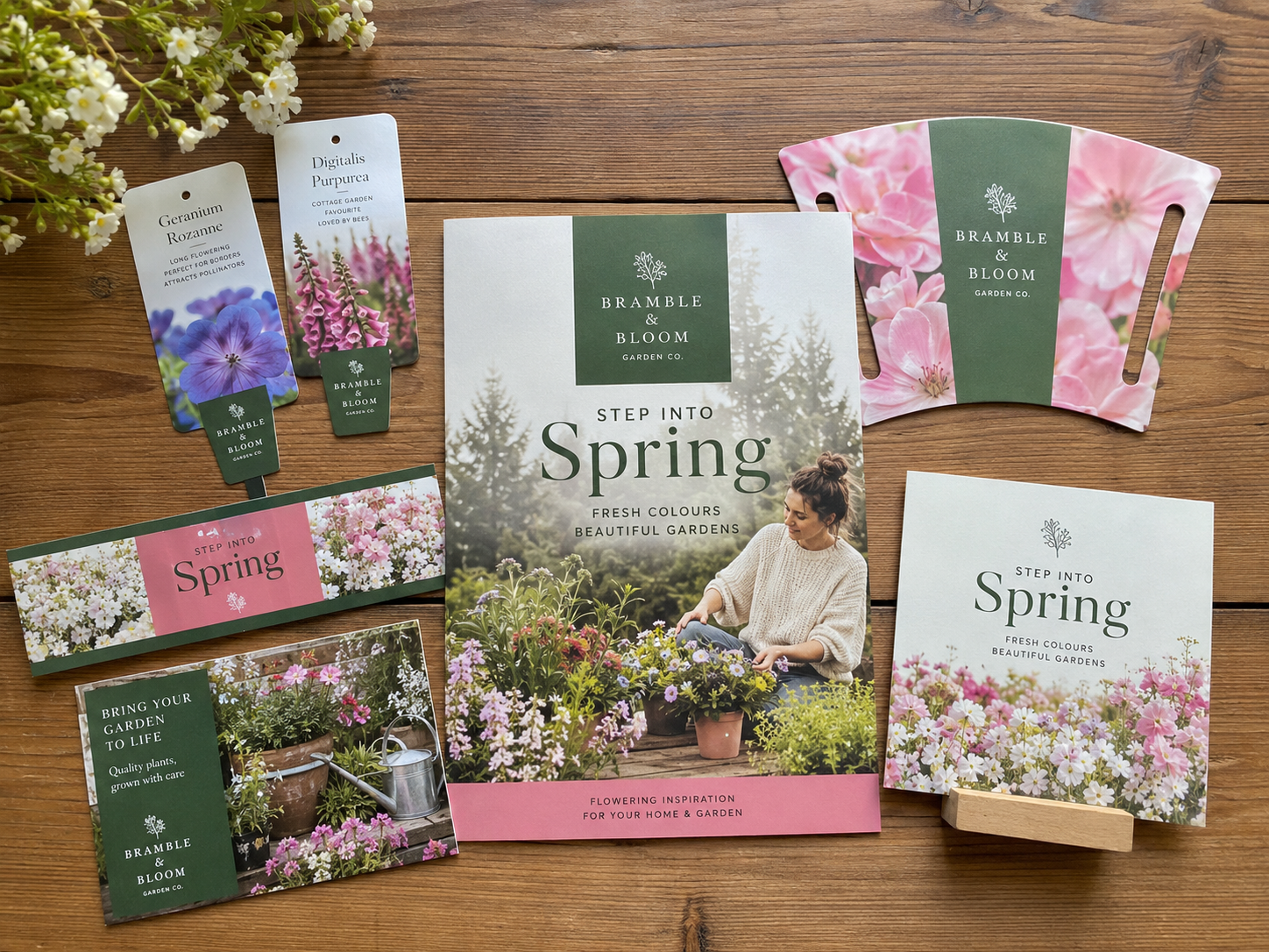 Seasonal campaign materials flat-lay including plant labels, carry handles, shelf strips and a brochure